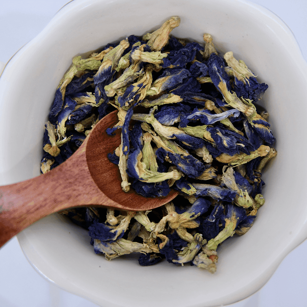 Deep cobalt blue butterfly pea flower tea in a glass cup