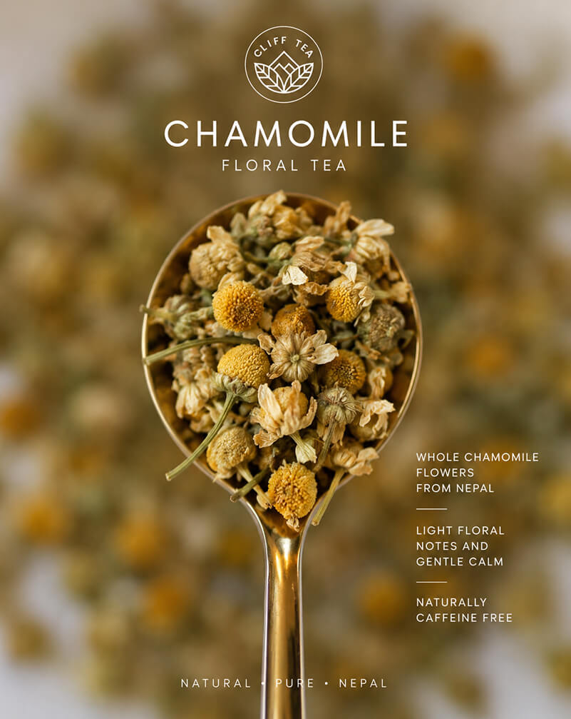 Chamomile flowers and tea cup on wooden surface