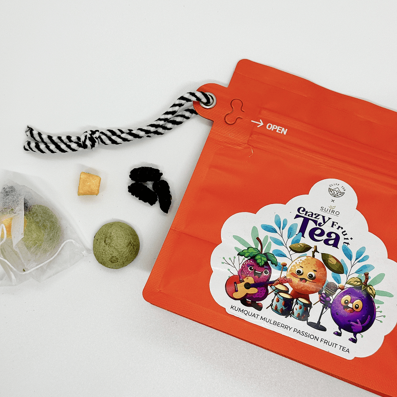 Crazy Fruit Tea pouch carrying the Cliff Tea and SUIRO marks, with sachets and dried kumquat and mulberry beside it