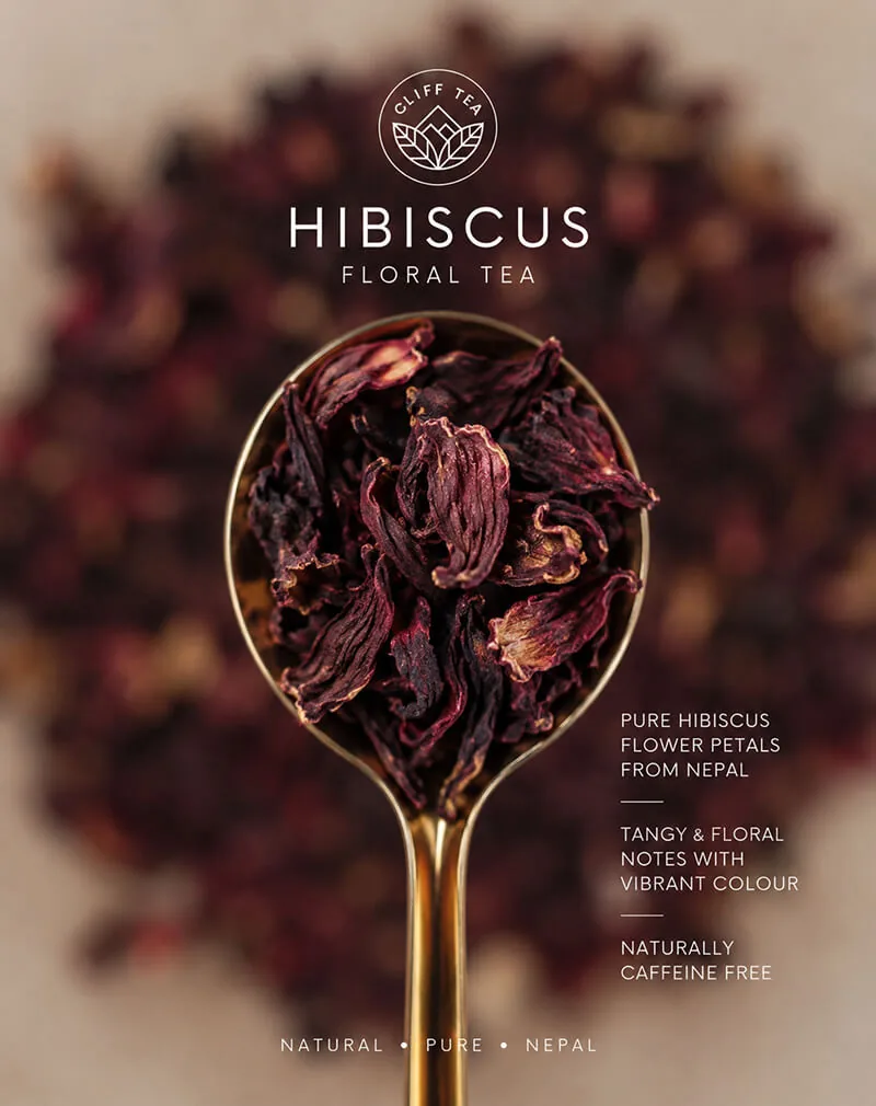 Whole dried hibiscus flowers next to a cup of deep red hibiscus tea