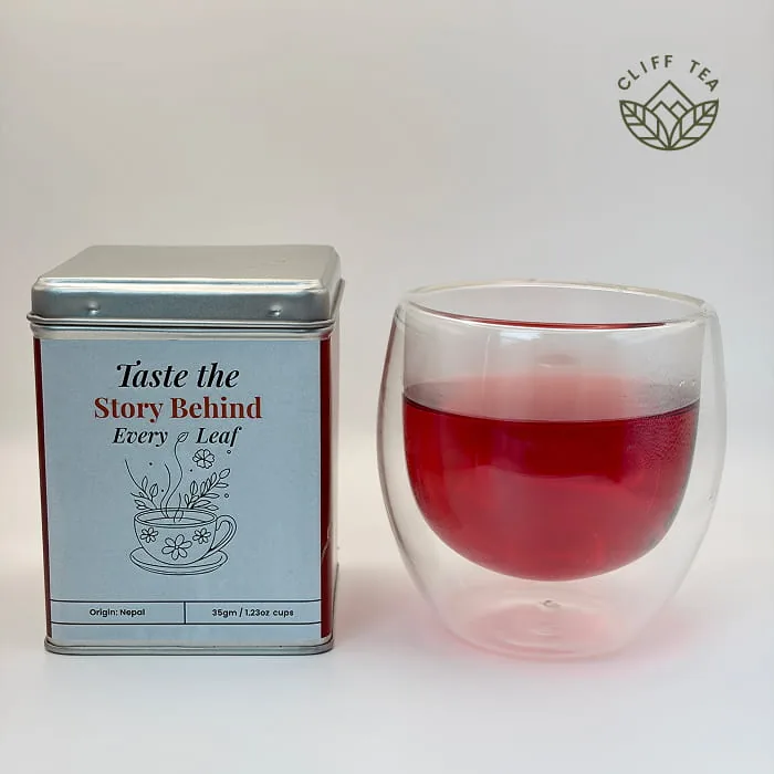 Whole dried hibiscus flowers next to a cup of deep red hibiscus tea